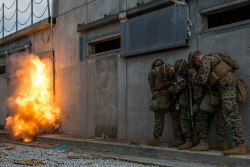 M7TH3F Combat engineers with Battalion Landing Team, 1st Battalion, 1st Marines, 31st Marine Expeditionary Unit, detonate a door breaching charge during Military Operations in Urbanized Terrain training at Camp Hansen, Okinawa, Japan, March 7, 2018. The combat engineers with BLT 1/1, part of the ground combat element for the 31st MEU, use various mechanical and ballistic techniques to clear and secure buildings in urban environments. As the Marine Corps' only continuously forward-deployed MEU, the 31st MEU provides a flexible force ready to perform a wide range of military operations. (U.S. Marine Co